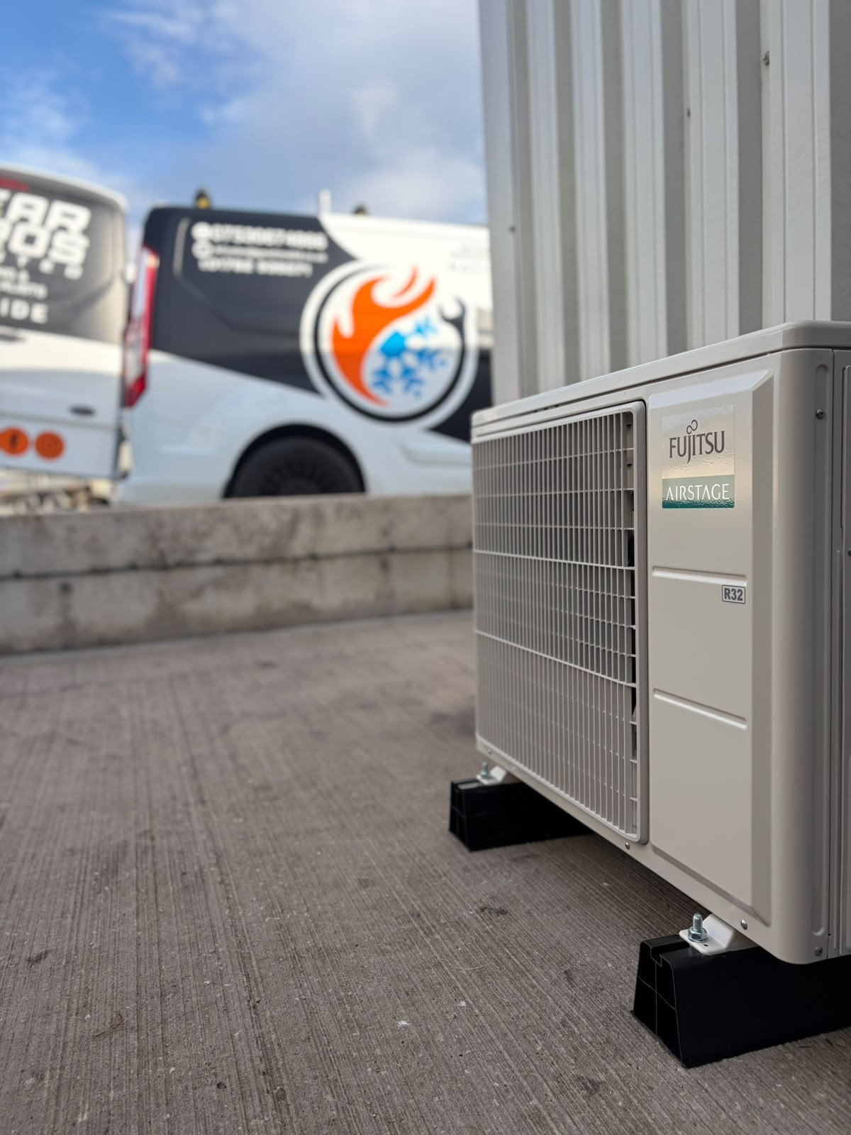Fujitsu Airstage outdoor condenser unit with a Gear Bros Ltd van on site