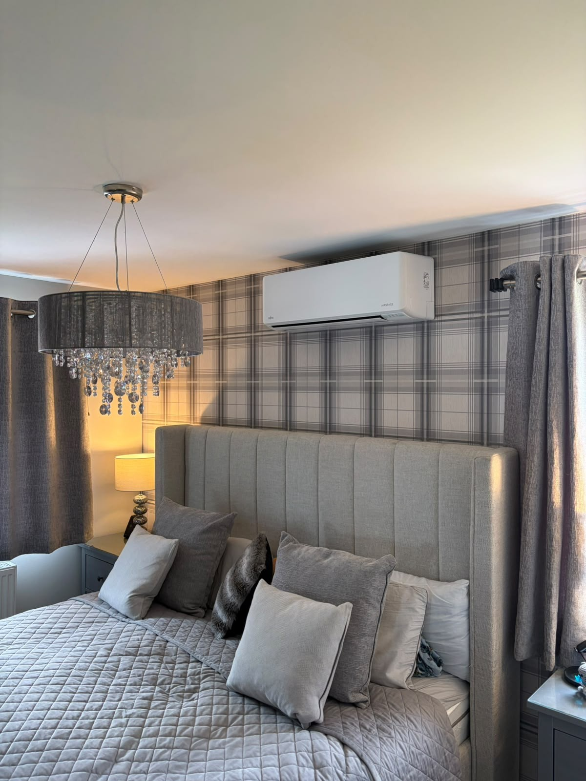 Fujitsu Airstage wall-mounted air conditioning unit installed in a bedroom